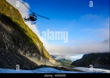 Helicopter transporting tourists into Fox Glacier, South Island, New Zealand Stock Photo