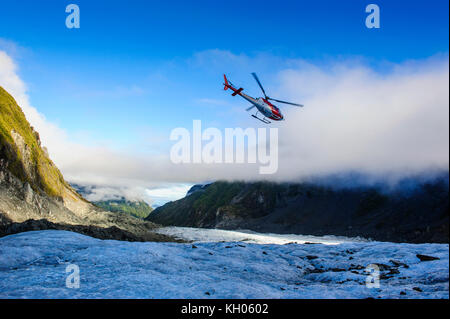 Helicopter transporting tourists into Fox Glacier, South Island, New Zealand Stock Photo