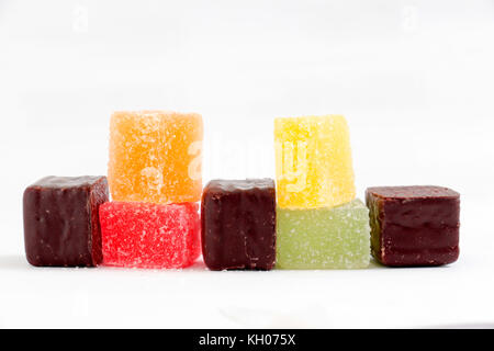 Colored Sweet jellies and chocolate bonbons on white bakground, image of a Stock Photo