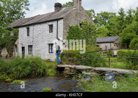 Clapper bridge over Malham Beck, Malham, North Yorkshire, England, UK Stock Photo