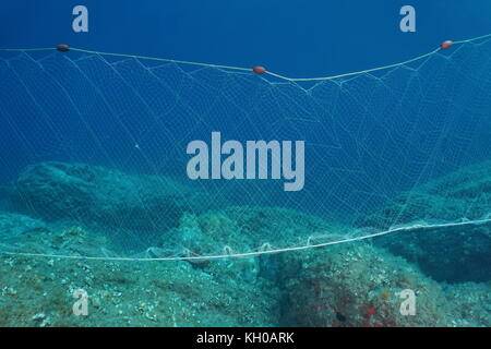 Fishing net underwater a gillnet fixed on a rocky seabed in the  Mediterranean sea, Cap de Creus, Cadaques, Catalonia, Costa Brava, Spain  Stock Photo - Alamy