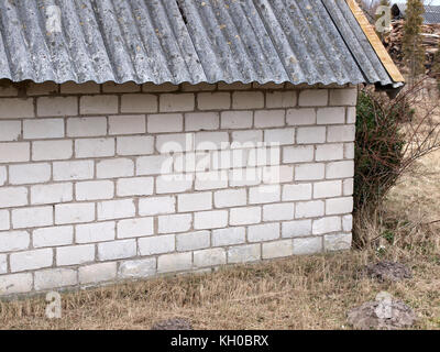 Small house or barn wall from white silicate bricks close up. Stock Photo