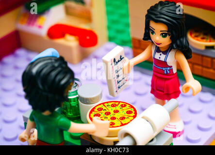 Tambov, Russian Federation - June 22, 2017 Lego girl with recipe and boy cooking pizza in Pizzeria kitchen. Studio shot. Stock Photo