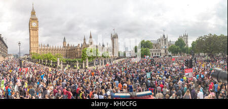 Protesters carrying anti-austerity placards and banners are pictured taking part in an anti-austerity march and demonstration in central London. It was the largest protest since the Conservative government was elected.