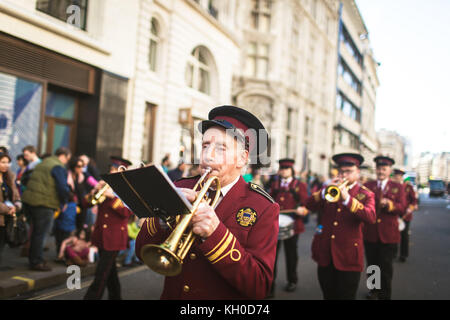 A horn musician plays a trumpet in a marching band at the annual Saint Patrick’s Parade in London. UK 16/03 2014. Stock Photo