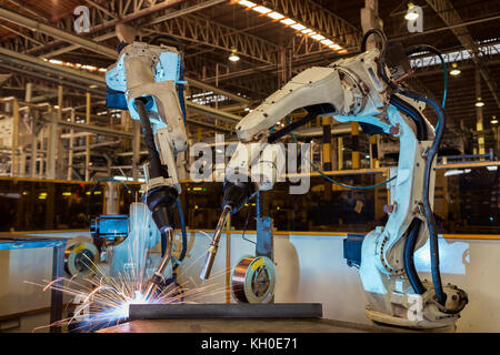 Industrial robot welding metal part Stock Photo