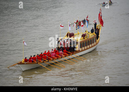 London’s new Lord Mayor Charles Bowman travelled aboard the Queen’s Rowbarge Gloriana accompanied by a flotilla of traditional Thames boats on River Thames London Stock Photo