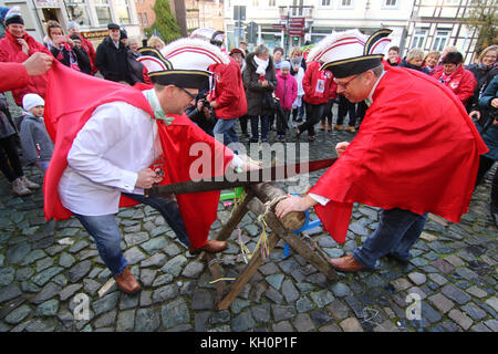 Blankenburg, Germany. 11th Nov, 2017. The gay princely couple Roland I. (R, Roland Vogeley) and Marco I. (Marco Foitzik-Vogeley) sawing a tree trunk at the Marktplatz after their marriage in the city of Blankenburg, Germany, 11 November 2017. The two men are the first princely couple to have tied the knot ahead of the start of the carnival season after the legalisation of gay marriage in Germany. Credit: Matthias Bein/dpa-Zentralbild/dpa/Alamy Live News Stock Photo