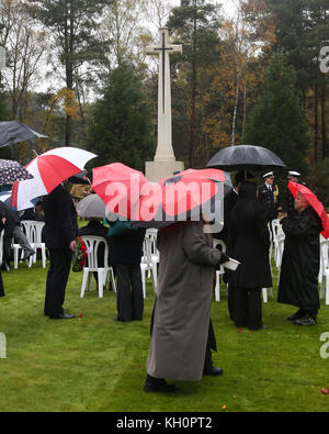 Participants wait in the rain for the commencement of the Canadian Service of Remembrance at CWGC Cemetery at Brookwood in Surrey on Armistice Day Stock Photo