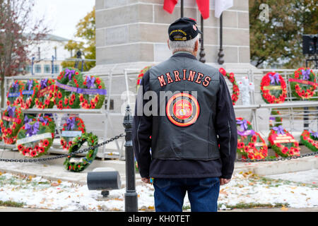 Native American/First Nations elder Vietnam War veteran looking at poppy wreaths at the London Cenotaph, Remembrance Day, London, Ontario, Canada Stock Photo