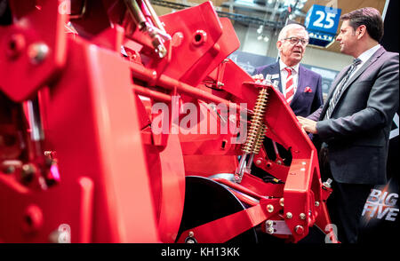 Managing Director Franz Grimme and the Minister of Economy for the state of Lower Saxony, Olaf Lies, watching a a self-propelled potato harvester at the stand of the Grimme company in the agricultural technology fair Agritechnica in the Hanover Convention Center in Hanover, Germany, 13 November 2017. About 2800 exhibitors will present their newest products at the international exhibition for agricultural technology taking place between 12 and 18 November. Photo: Hauke-Christian Dittrich/dpa Stock Photo