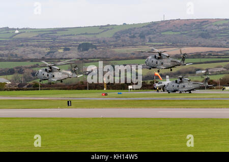 RNAS Culdrose, Cornwall, UK. 13th November, 2017. RNAS Culdrose aviation units conisting of Merlin MK2 and Sea King ASACHelicopters approach to land on the dummy deck at RNAS Culdrose alongside F35B Lightning replica aircraft. The exercise was to simulate a Carrier Air Group embarkation during Exercise Kernow Flag. The 'embarkation' of multiple Royal Navy aircraft from RNAS Culdrose today. EXERCISE Kernow Flag has begun. With a new era of 'carrier aviation' just around the corner, Exercise Kernow Flag will help Culdrose to get 'Carrier Ready' through an intensive flying programme and test the  Stock Photo