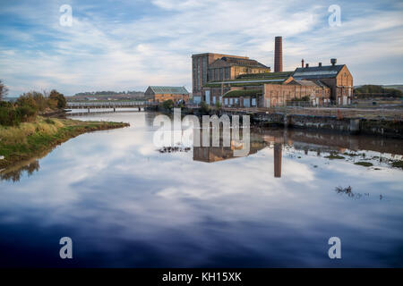 Old Factory Building reflects in the Water Stock Photo