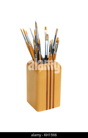 Artist's brushes in a wooden container against a white background Stock Photo