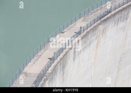 GIBIDUM DAM, NATERS, SWITZERLAND - September 22, 2017: Minimal and abstract top view of a concrete manmade hydroelectric power dam with the lake. Stock Photo