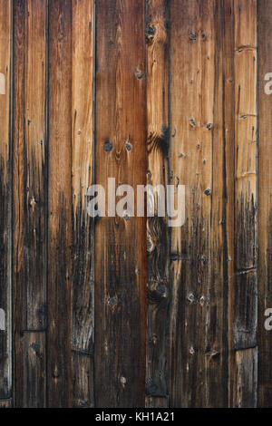 Vertical weathered old wood planks with a gradient from dark to light. Stock Photo