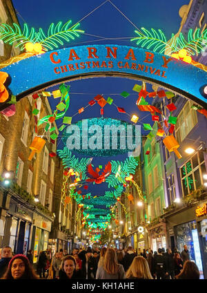 Carnival theme Christmas decorations in Carnaby Street in the West End of London 2017 Stock Photo