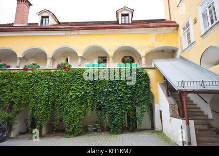 Körblerhaus inner courtyard, medieval house in Judenburg with arcades on octagonal columns, with pointed and pressed round arches from 16th century. Stock Photo