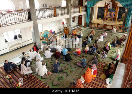 Krishna parishioners sitting on a floor and listening to guru in a temple. April 3, 2017. The Krishna temple, Kiyv, Ukraine Stock Photo