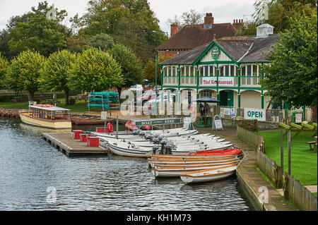 The old boathouse on the banks of the River Avon in the centre of Stratford upon Avon is one of the locations tourists can hire a variety of boats. Stock Photo