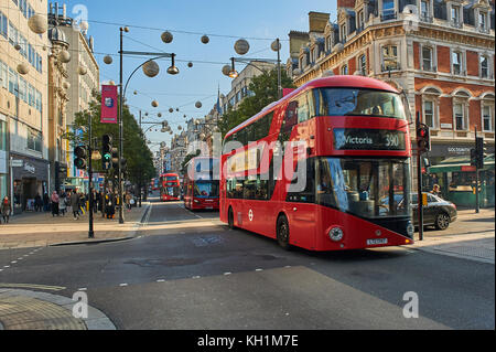A red double decker bus in London's West End travels down Oxford Street. London buses are a great way to travel around the city.