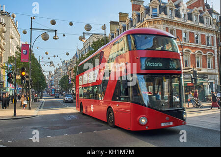 A red double decker bus in London's West End travels down Oxford Street Stock Photo