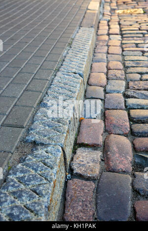 curbstone separating the pavement and the road Stock Photo