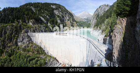 GIBIDUM DAM, NATERS, SWITZERLAND - September 22, 2017: Panorama of a large hydroelectric power dam situated in the forest covered mountains of Wallis. Stock Photo