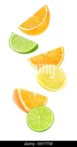 Isolated falling citrus pieces. Slices of orange, lemon and lime in the air isolated on white background with clipping path Stock Photo