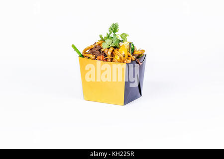 Chinese food. Stir fry noodles with meat on white background. In take away wok noodles box. Stock Photo