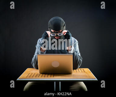 Short-sighted attacker wears glasses, he is preparing to start work Stock Photo