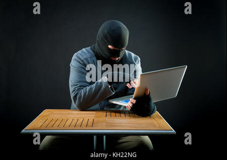 Hacker at work on black background Stock Photo