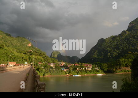 Rainbows above Nong Khiaw, Laos, in the early evening light Stock Photo