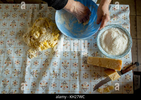 old woman making homemade pasta with parmesan cheese Stock Photo