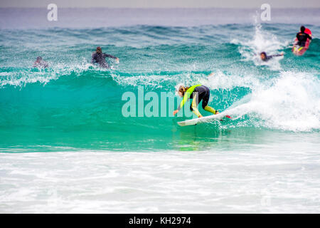 A surfer ride a wave at Sydney's iconic Bondi Beach, NSW, Australia Stock Photo