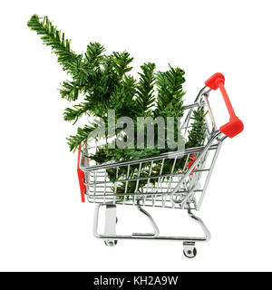 Isolated objects: toy Christmas tree in a shopping cart, on white background, seasonal shopping concept Stock Photo