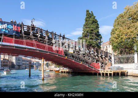 Restoration work being carried out on the Accademia Bridge, Grand Canal, Venice, Veneto, Italy funded by the eye glasses company Luxottica Stock Photo