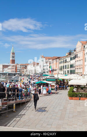 Large crowd of tourists who have just disembarked of a day tour ferry descending on Riva degli Schiavoni, Castello, Venice, Italy. T Stock Photo