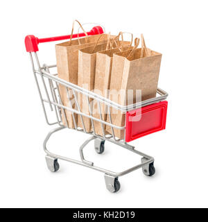 metal shopping cart with craft paper bag isolated on white background, close up, concept Stock Photo