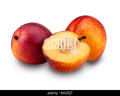 Two ripe nectarine fruits and one cut in half  isolated on white background. Clipping Path Stock Photo