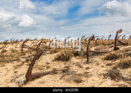 Natural Cemetery of Marine Anchors at Barril Beach on the southern Portuguese coast of the Atlantic. Stock Photo