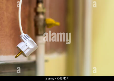 White electric plug cable isolated on blurred background Stock Photo