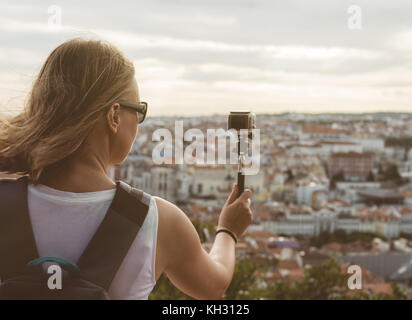 Woman traveller with camera shooting video. Stock Photo