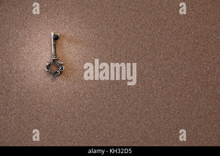 old key on a cork board Stock Photo