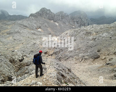 Man alone in karst mountains of the Julian Alps, Slovenia, July 2017. Stock Photo