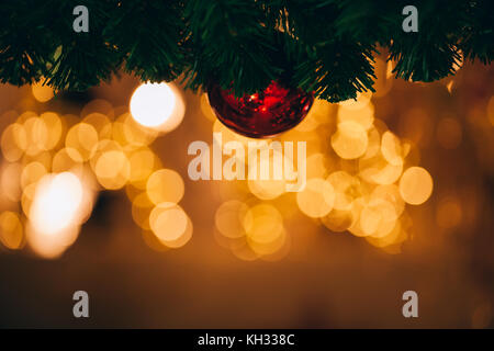 Beautiful decorated Christmas tree background with bauble and xmas ornaments blurred in gold bokeh Stock Photo