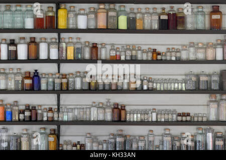 Laboratory jars lined up on shelves in a chemistry lab Stock Photo