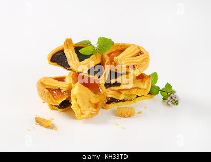 halves of apricot and plum jam tarts on white background Stock Photo