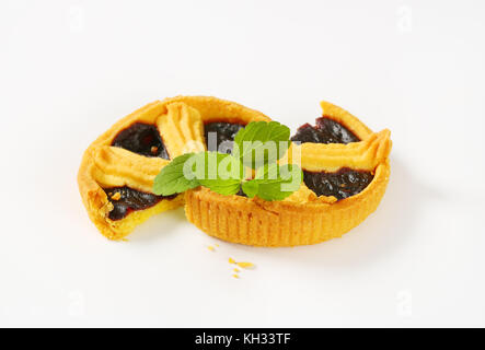 halved plum jam tart on white background Stock Photo