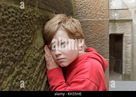boy listening at wall, Wallace Monument, Stirling, Scotland, Great Britain Stock Photo